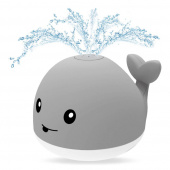 Vettä suihkuttava valas valolla Vettä suihkuttava valas valolla